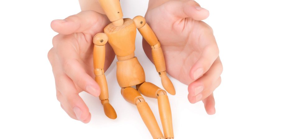 female hands covering wooden man